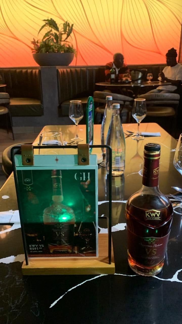 The terrace at sundown, the display trolley holding a bottle and the menu card, booth seating behind